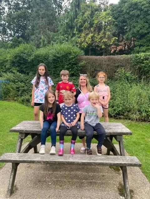 Grandchildren gathered round a picnic table
